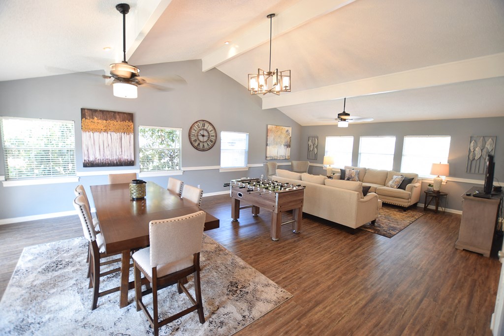 an open living room and dining room with couches and a table