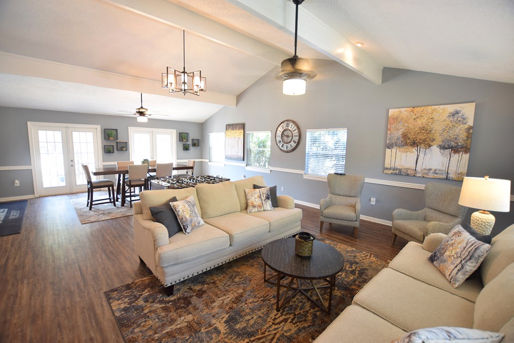 a living room with couches and chairs and a table