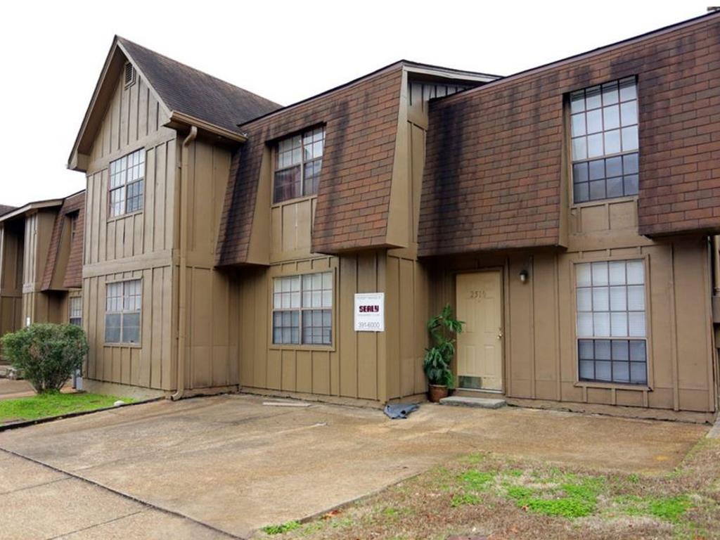 Apartment complex with a sign that says "For Rent".