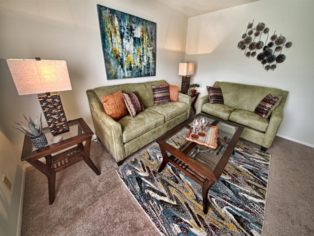 a living room with two couches and a table