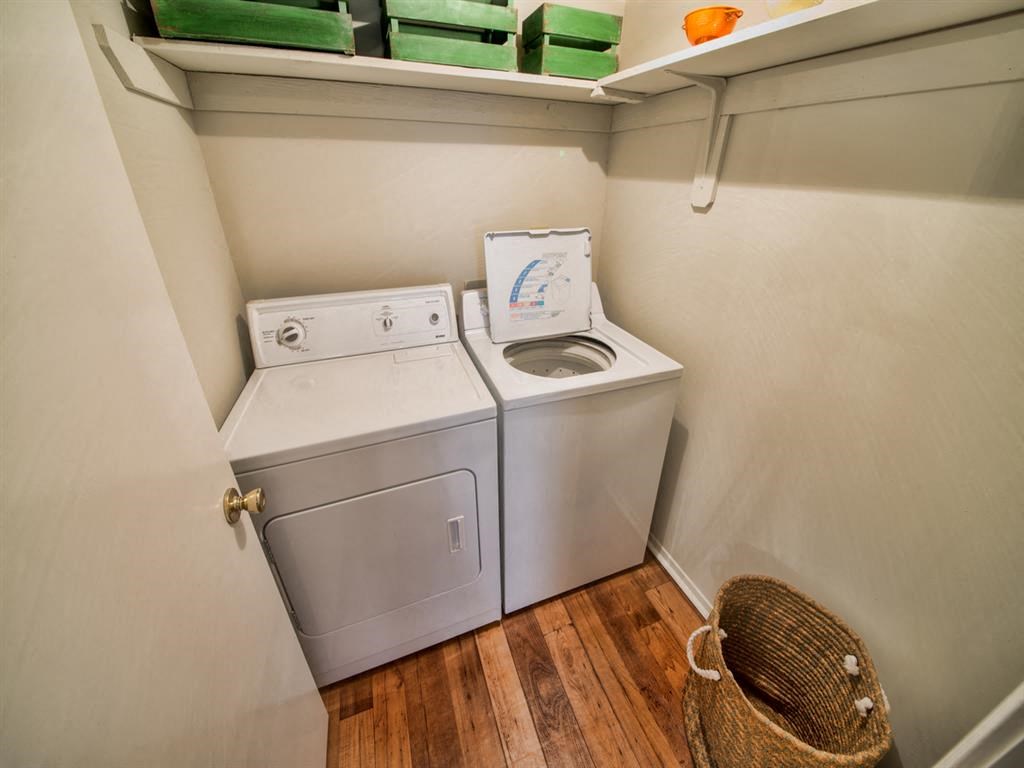 a white washer and dryer in a laundry room with a shelf above it