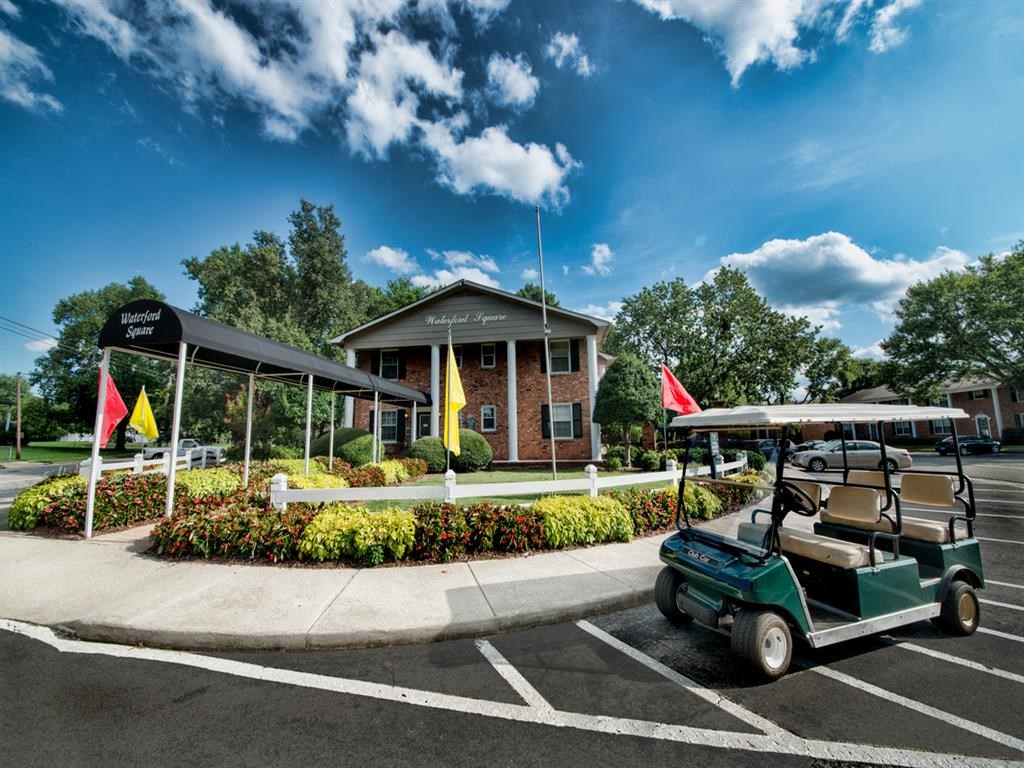 a golf cart parked in a parking lot in front of a building