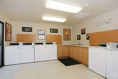 a kitchen with four washes and dryers in it
