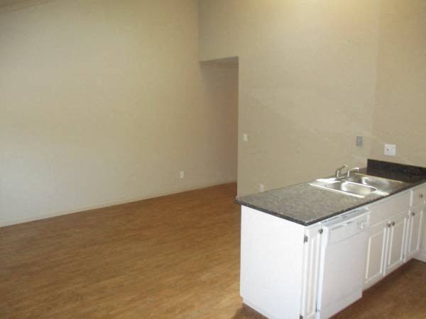 A kitchen with a sink and cabinets.