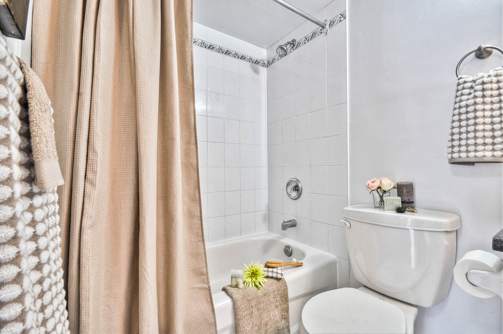 a bathroom with a toilet and a tub and a shower curtain