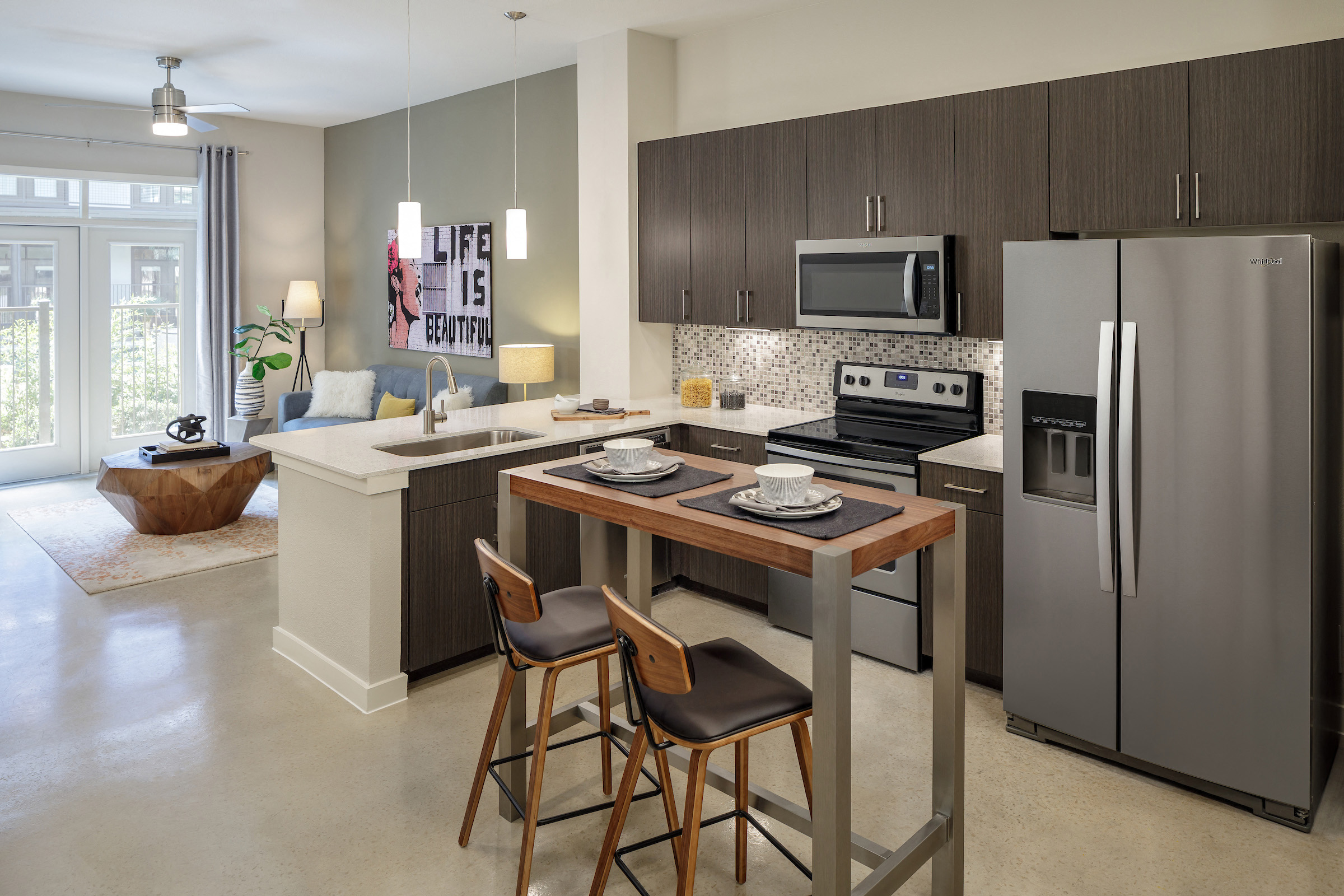 A modern kitchen with a table and chairs.
