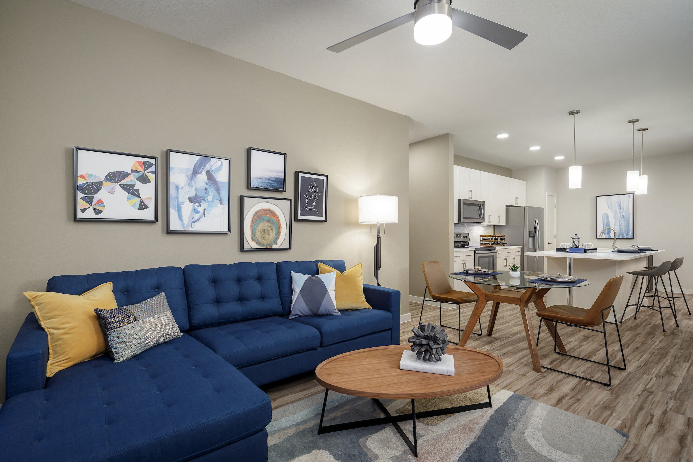 A living room with a blue couch and a coffee table.
