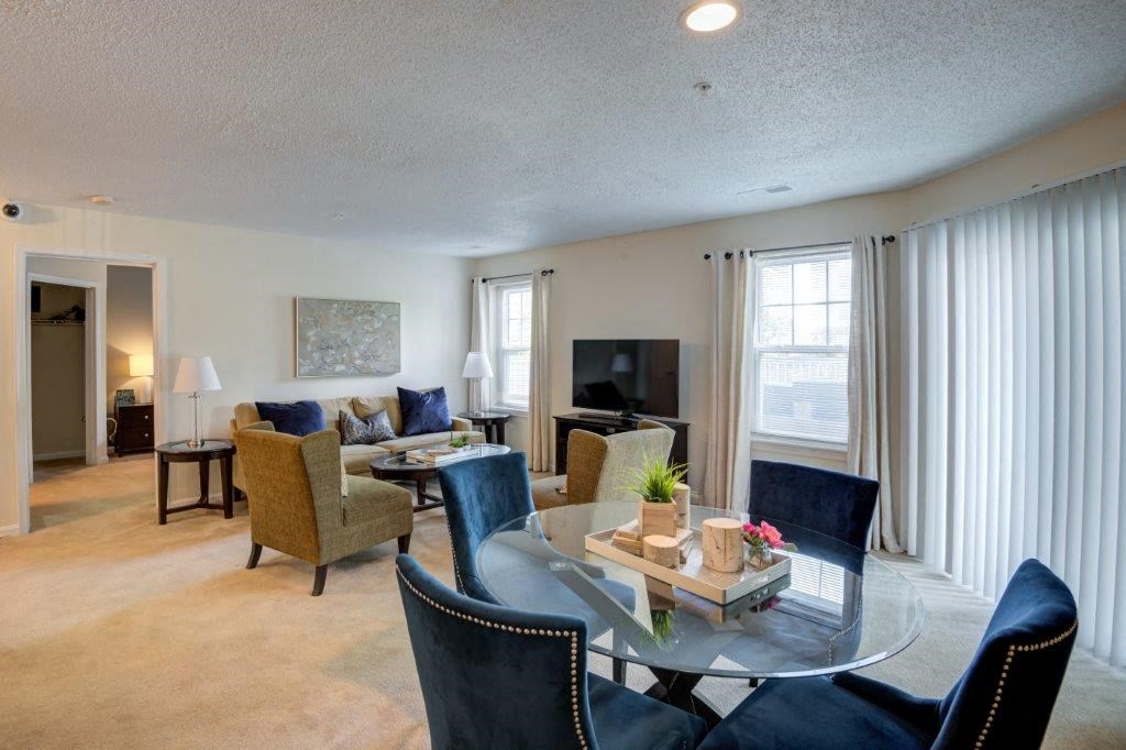 a living room with furniture and a glass table