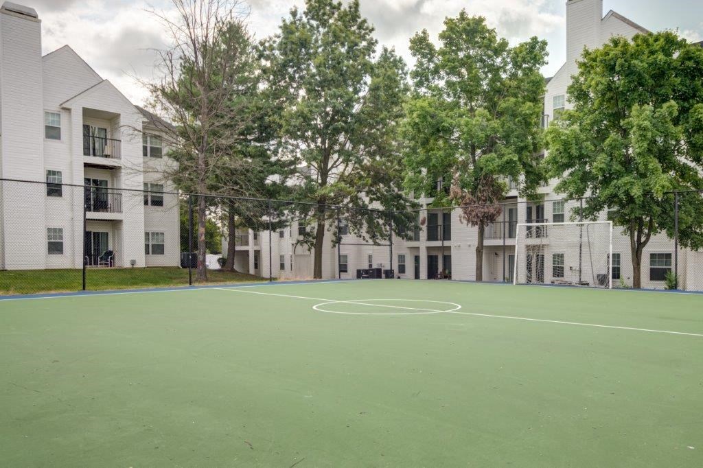 a basketball court in the middle of an apartment complex
