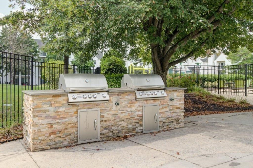 a stone outdoor kitchen with two gas burners on it