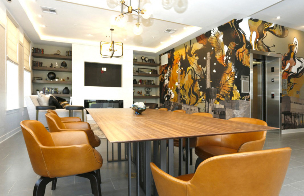 a dining room with a wooden table and leather chairs