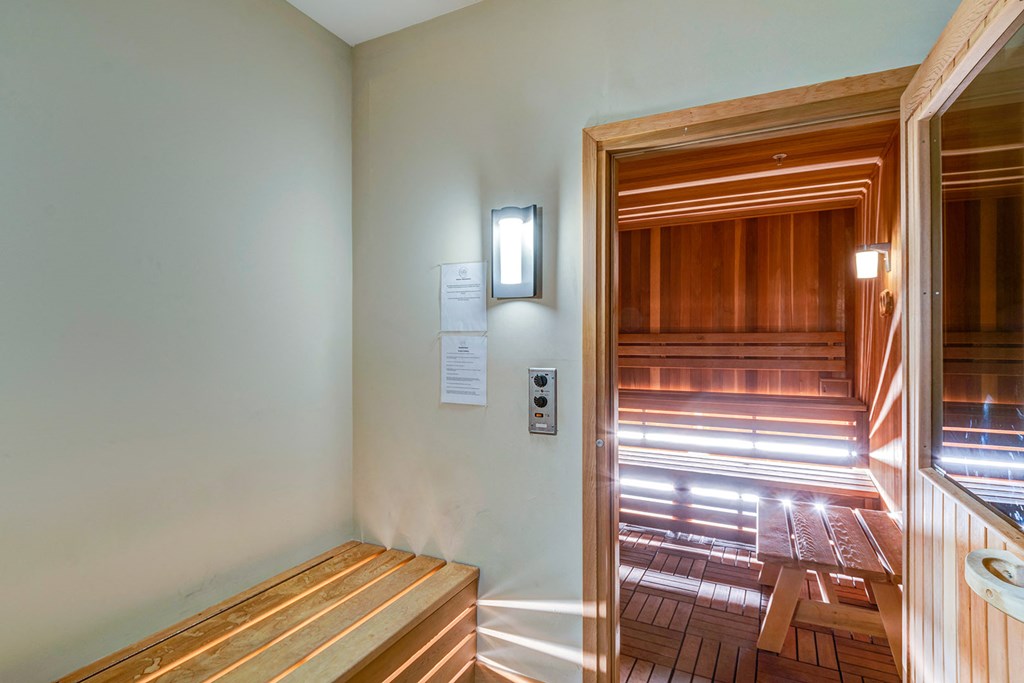 a room with a wooden bench and a door to a wooden