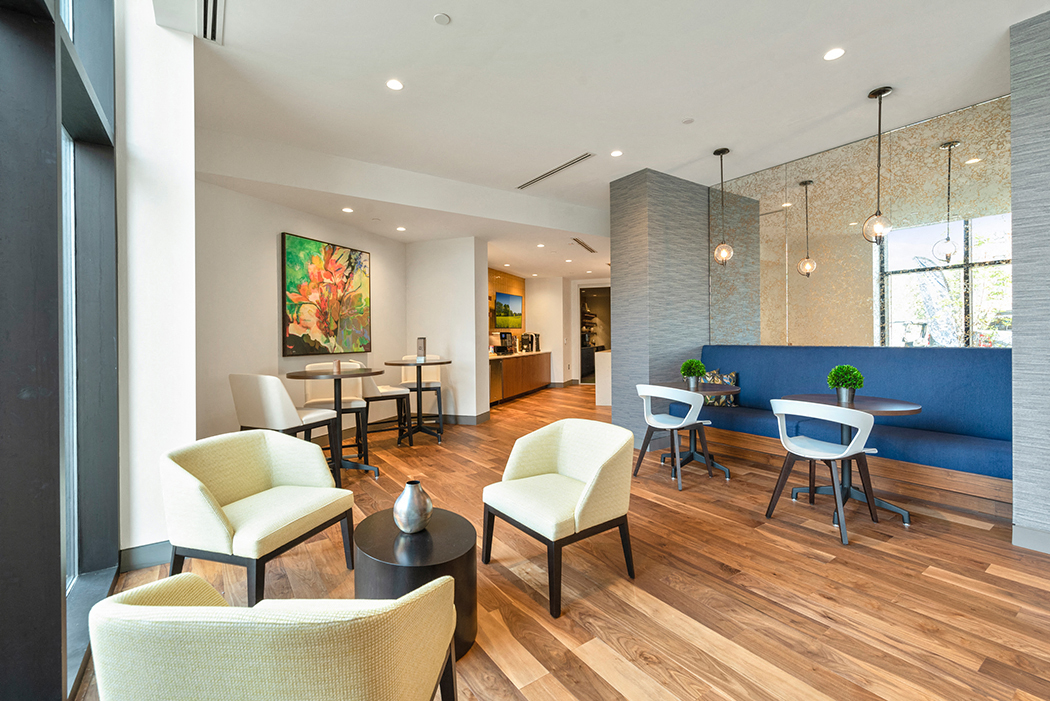 A resident lounge with several tables, chairs, and a complimentary coffee bar. at Keva Flats, Pennsylvania