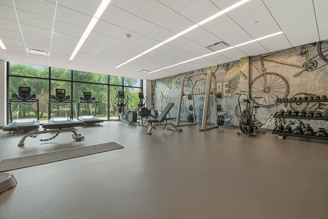 A state-of-the-art fitness with weight and cardio equipment and windows with beautiful view of green space  at Keva Flats, Pennsylvania