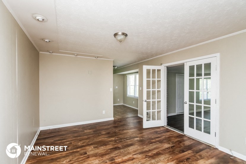 the living room and dining room of an apartment