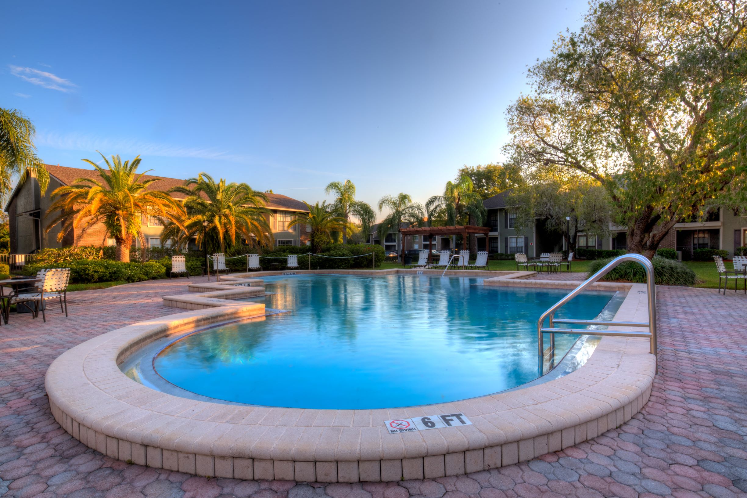 This is one of our three pools, with beautiful paver deck surrounded by lush landscaping.