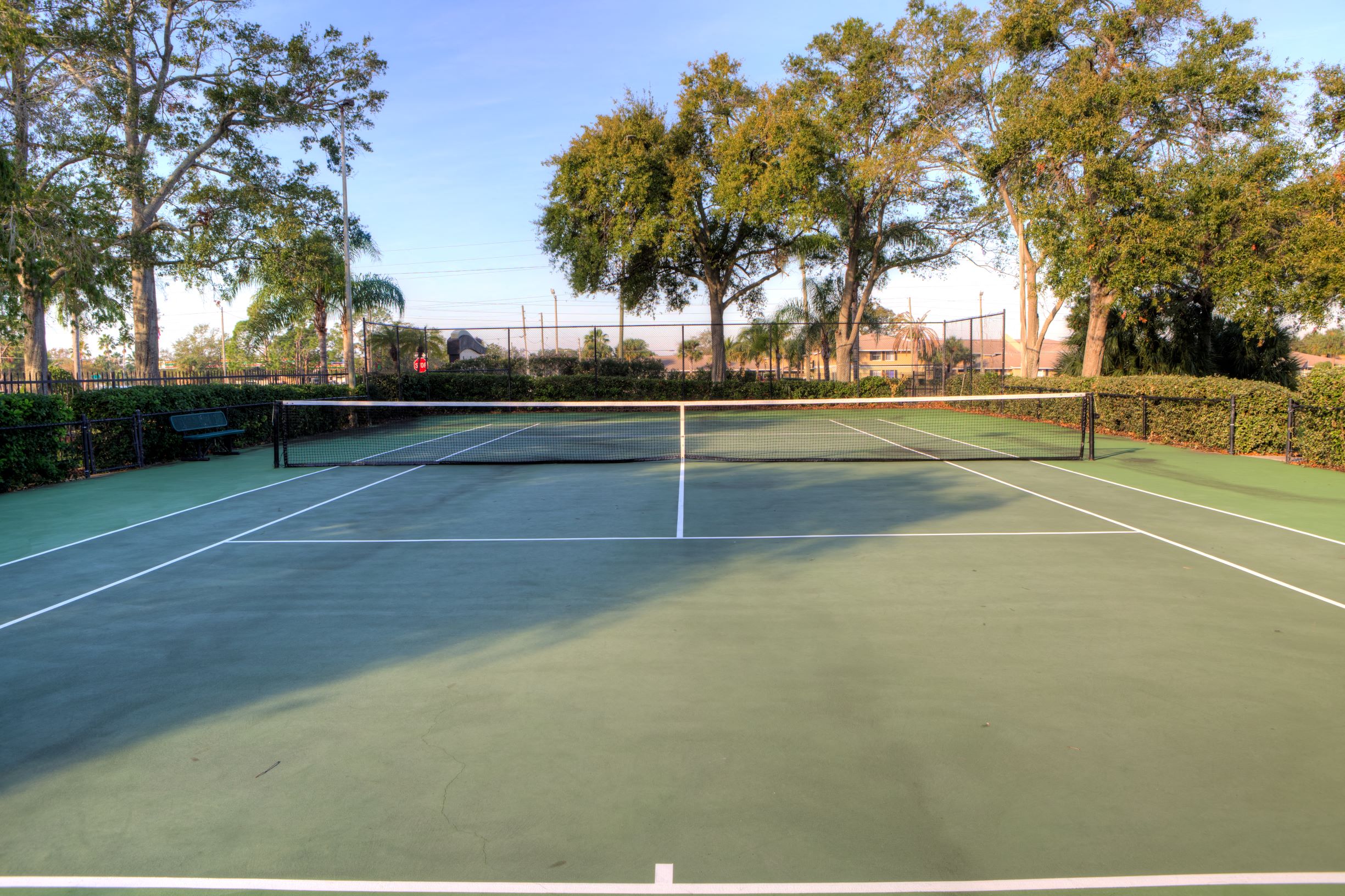 Two, hedge lined tennis courts offer a sweet spot for a game.