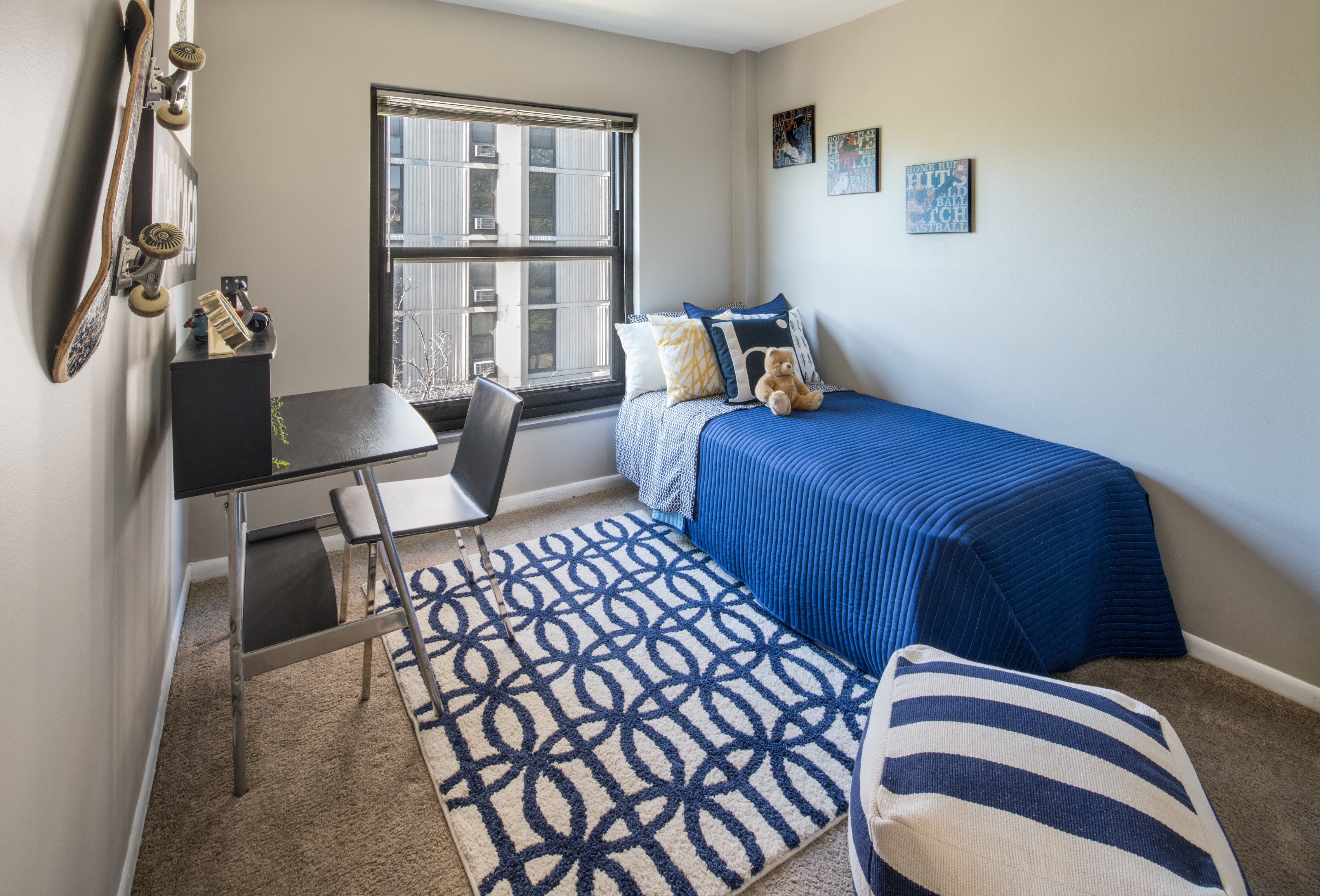 Bedroom photo with large window and blue furnishings at Eden Commons, Chicago