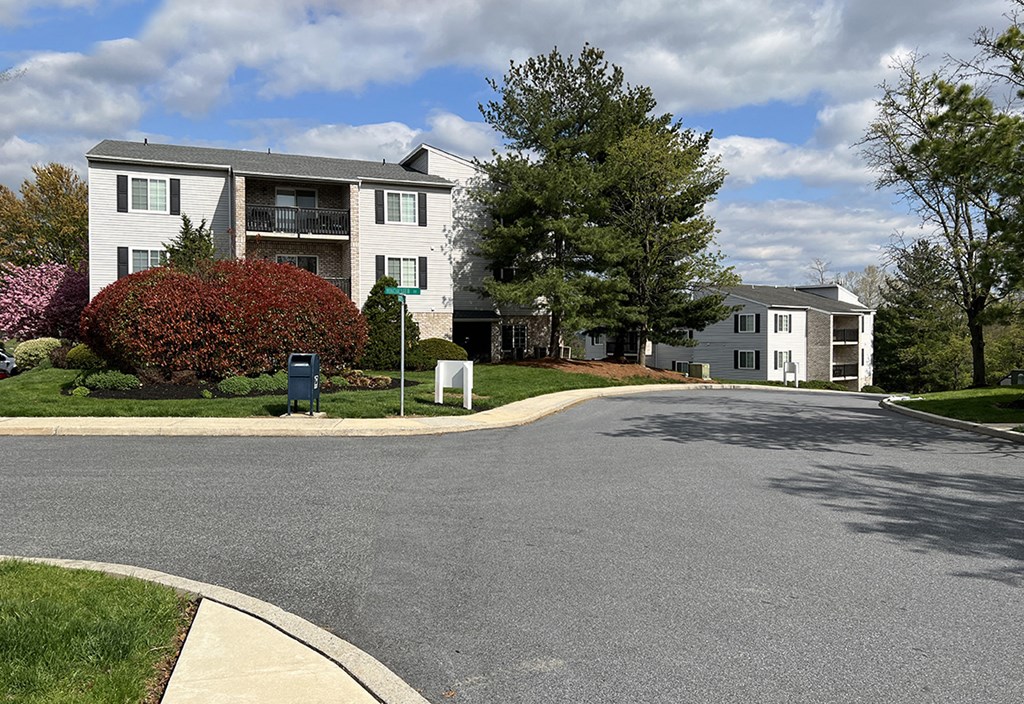 an empty street in front of an apartment building
