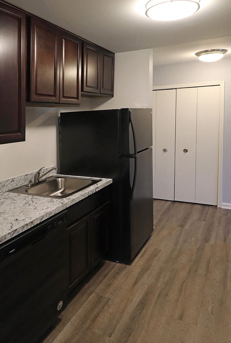 a kitchen with a sink and a refrigerator