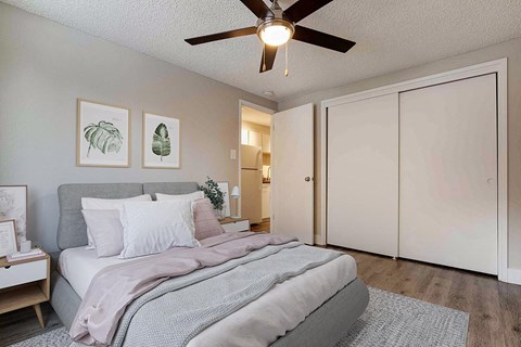 a bedroom with a bed and a ceiling fan