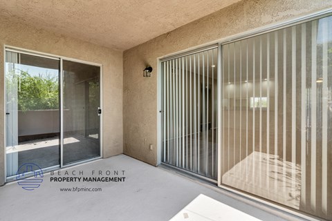 the condo patio has a sliding glass door to the pool