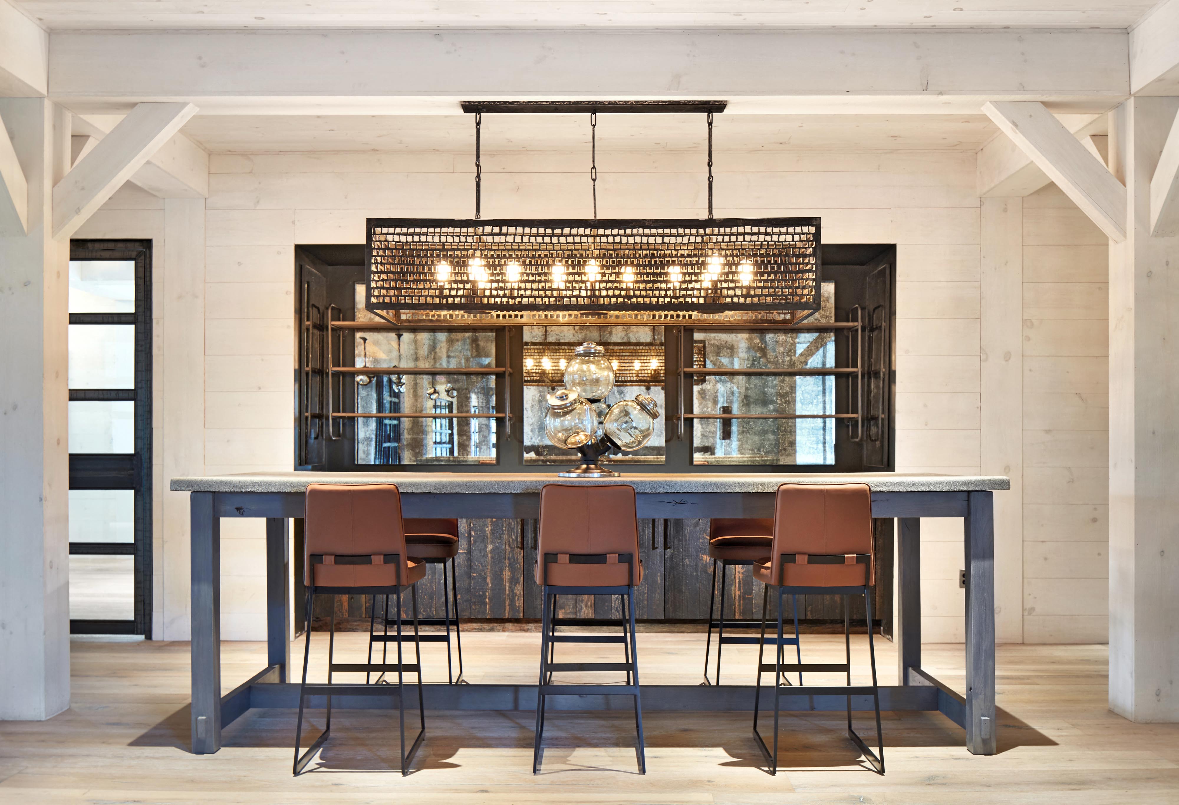 A modern dining room with a large table and chairs.