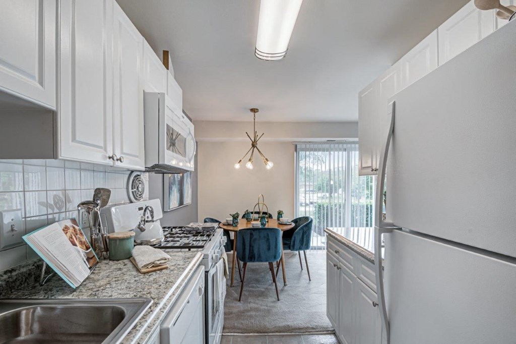 a kitchen and dining room with a stainless steel refrigerator