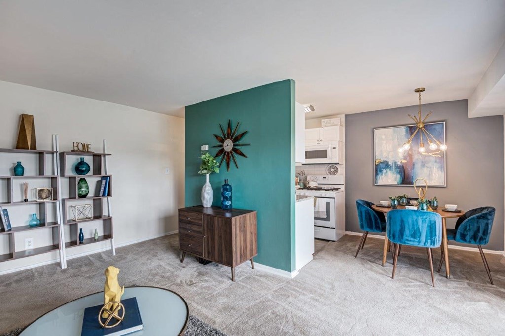 a living room and dining room with a green accent wall