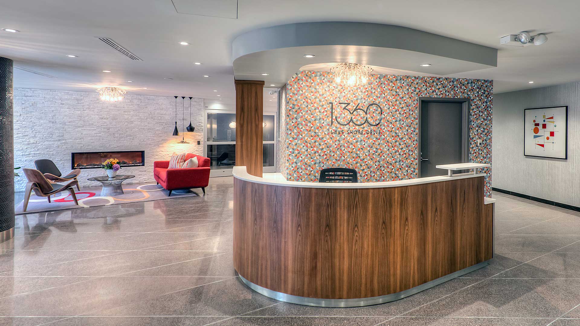 The front desk in the 1360 Lake Shore Drive lobby. A lounge area with fire place is seen further back to the left.