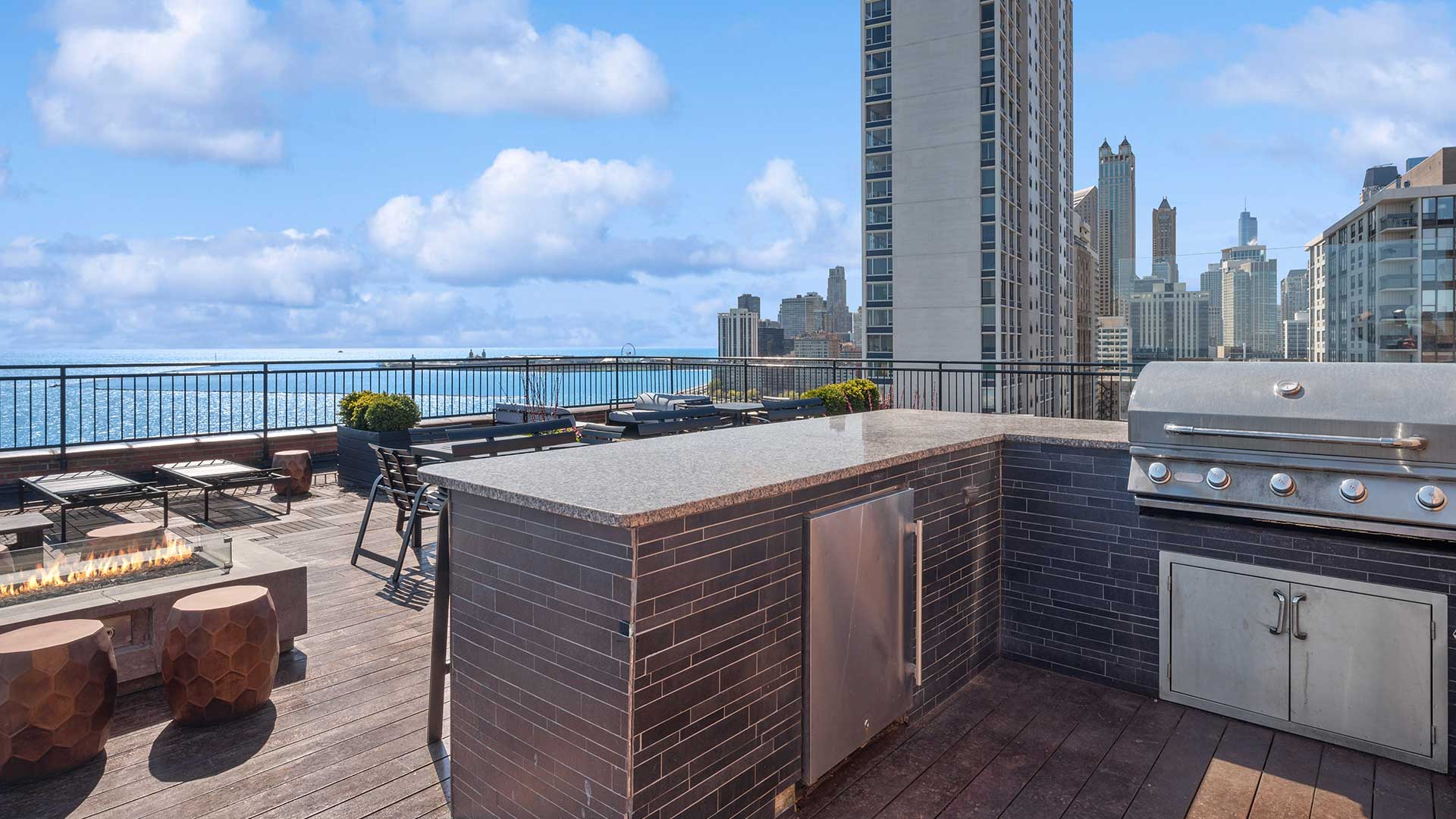 A grilling station on the rooftop deck. Lake Michigan and the Chicago skyline are in the background.