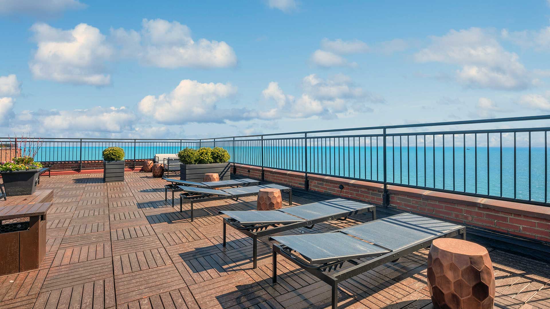 Looking across a row of lounge chairs on the roof deck.