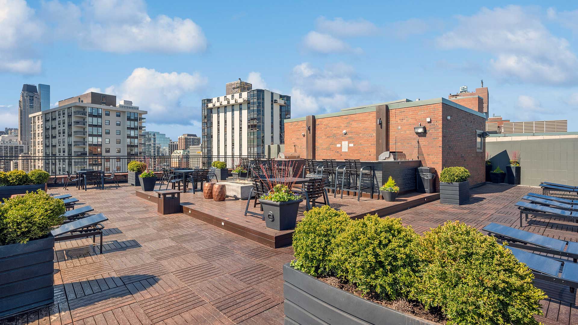 The rooftop deck at 1350-1360 Lake Shore Drive. The city rises in the background. The bar and grill are across the deck in the center.