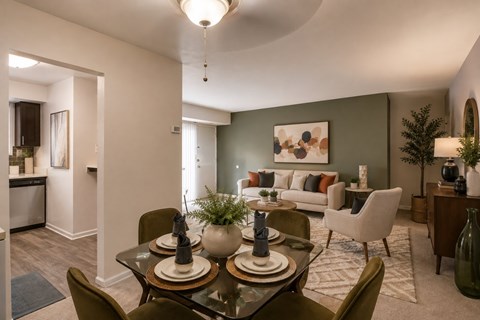 A modern dining room with a glass table and chairs.