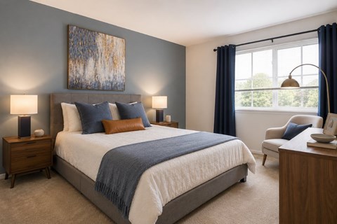 A bedroom with a large bed and a painting on the wall.
