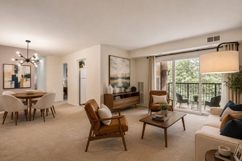 A living room with a brown chair and a white couch.