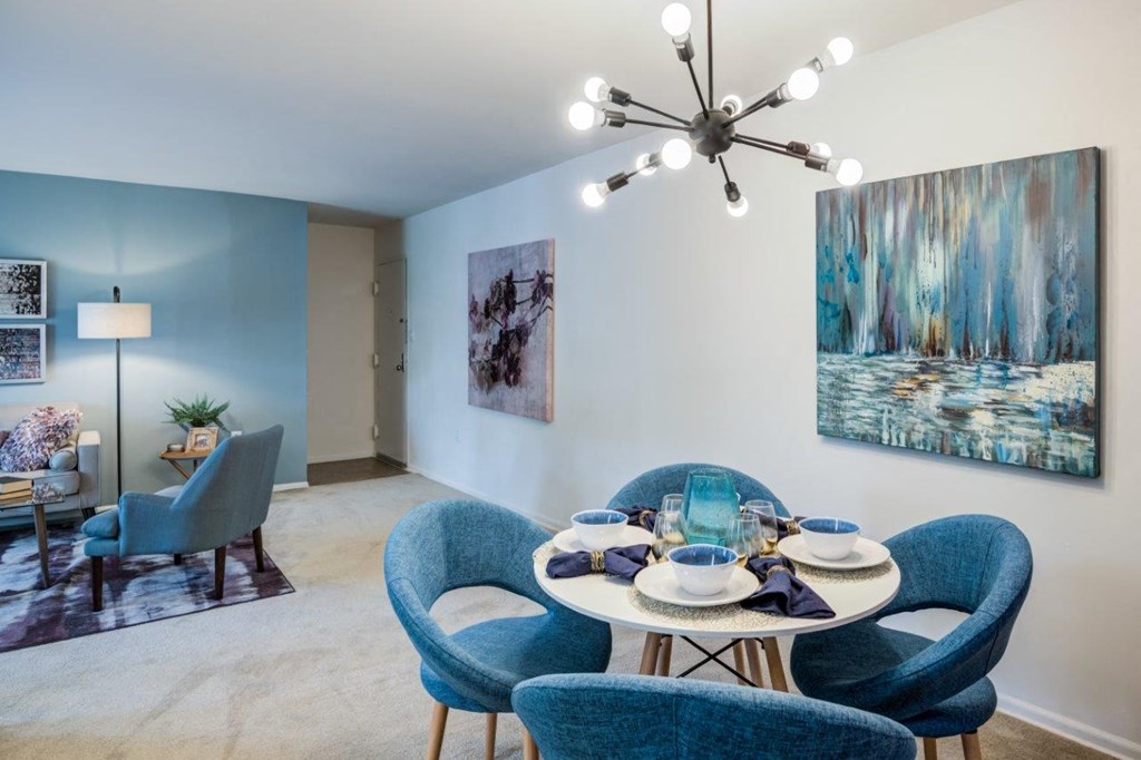 a dining room with a table and chairs and a chandelier