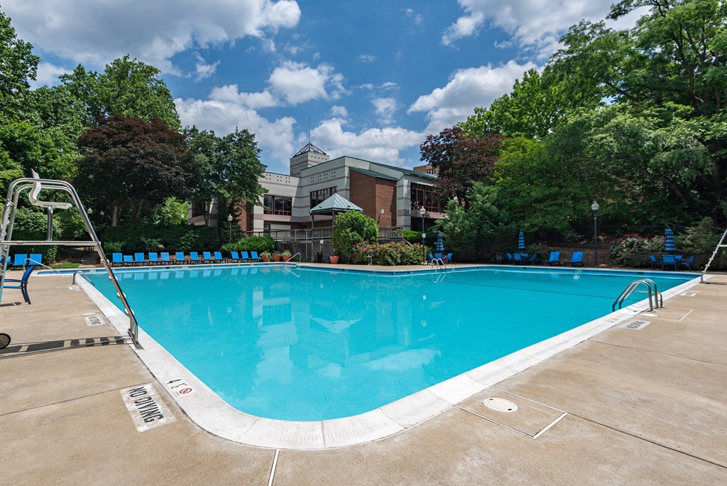 a swimming pool with a building in the background