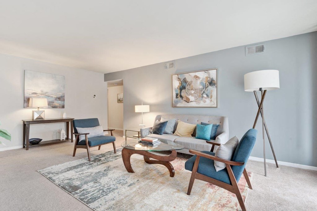 a living room with a couch and chairs