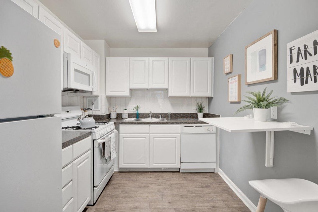 a white kitchen with white appliances and white cabinets