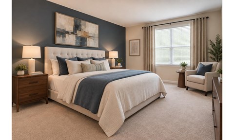 A bedroom with a large bed and a chair.