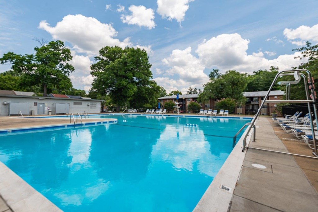 a large swimming pool with chairs around it