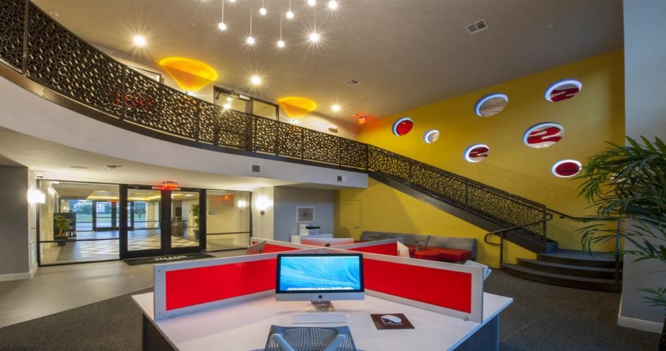 a large lobby with a computer on a desk