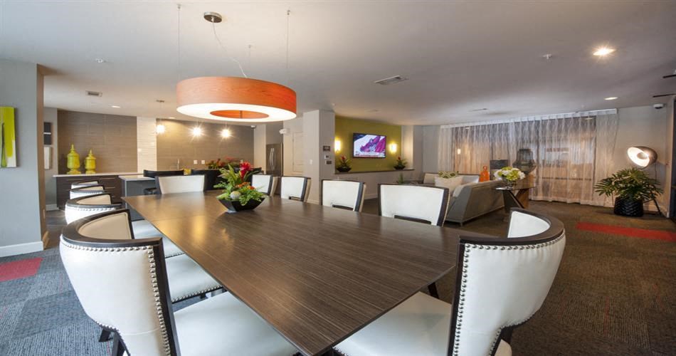 a large dining room table with white chairs