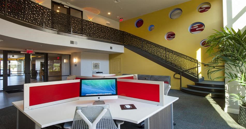an office with a desk with a computer on it