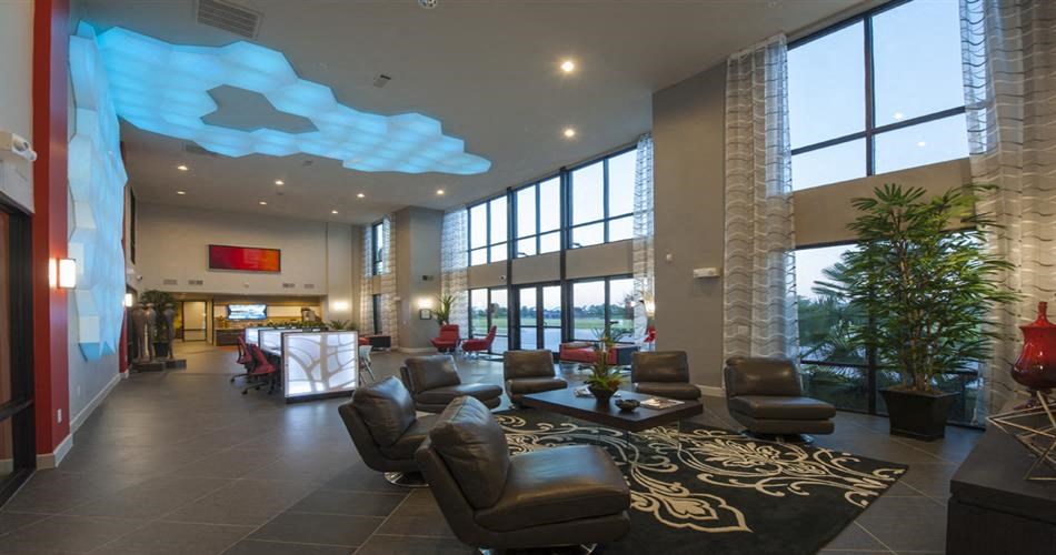 a lobby of a hotel with couches and chairs