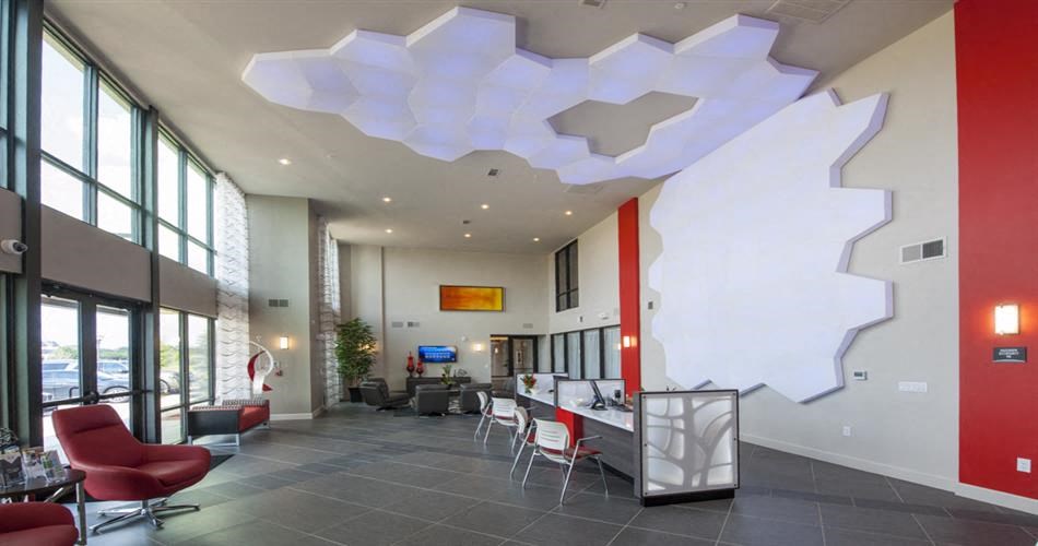 the lobby of a building with chairs and a table