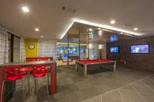 a game room with a pool table and chairs