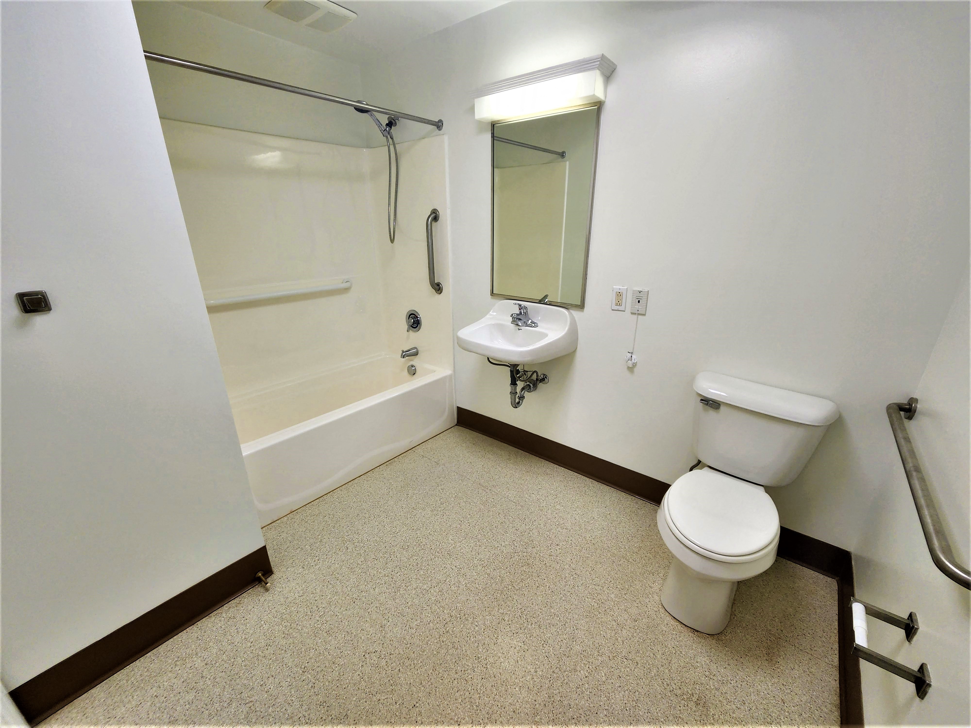 a bathroom with a toilet and a sink and a bath tub