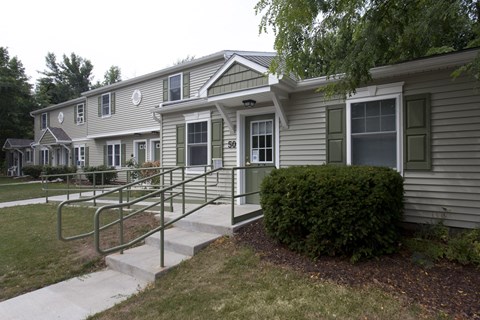 an apartment building with stairs to the front of it